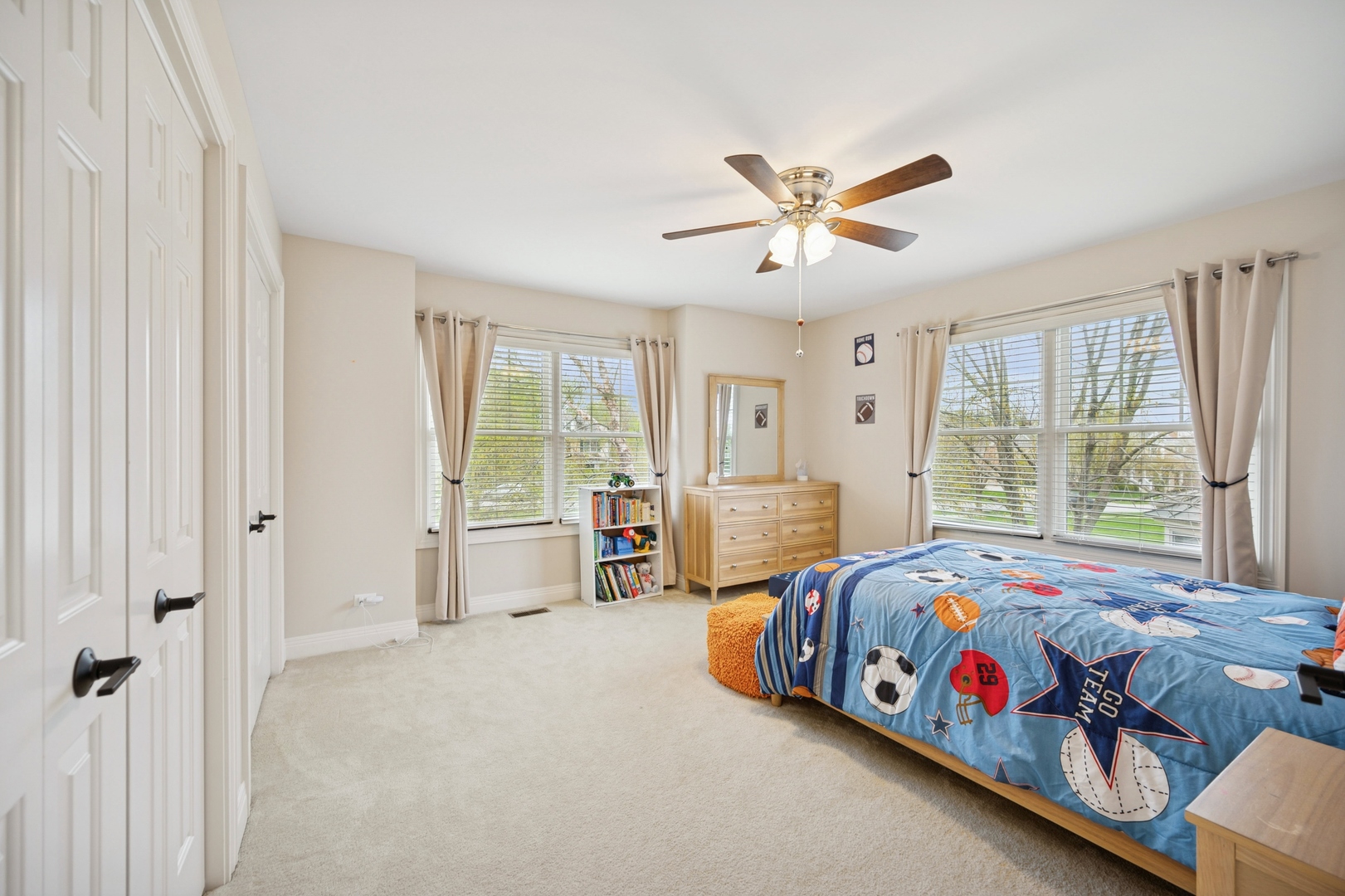 1437 Kittyhawk Lane Glenview, IL 60026 - Photo 16 of 24 a bedroom with a bed next to a window with a chandelier