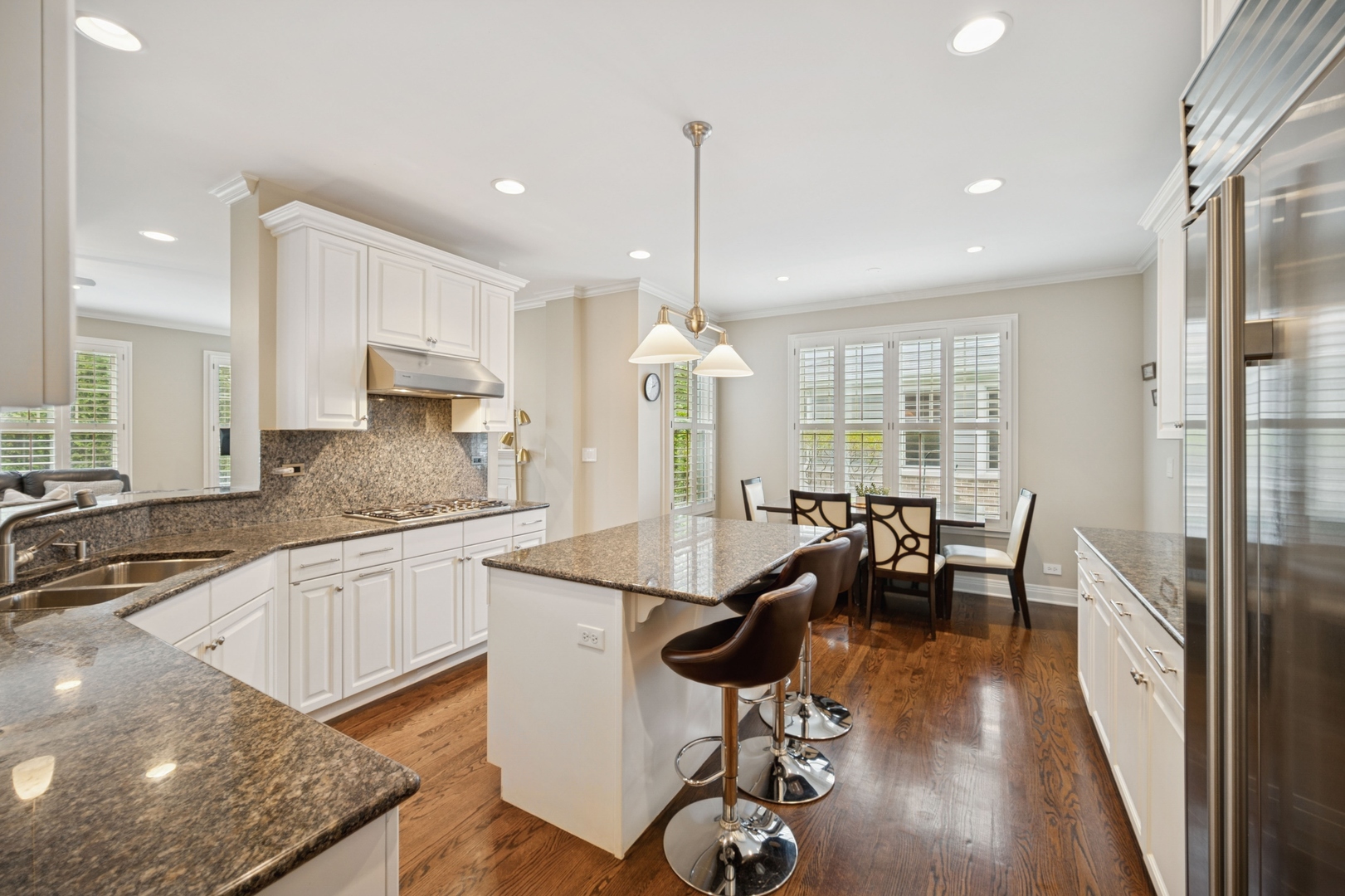 1437 Kittyhawk Lane Glenview, IL 60026 - Photo 8 of 24 a kitchen with granite countertop kitchen island stainless steel appliances a dining table chairs and granite counter tops
