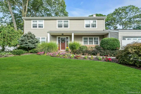 a front view of house with yard and green space