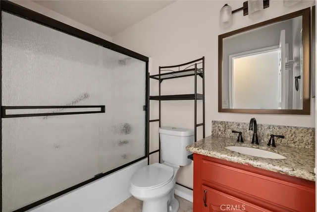 an empty room with wooden floor and chandelier fan
