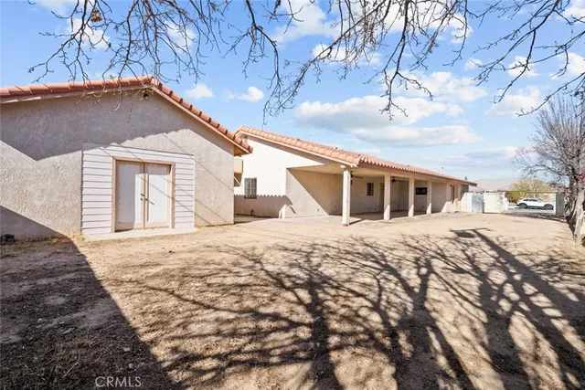a view of empty room with wooden floor and window