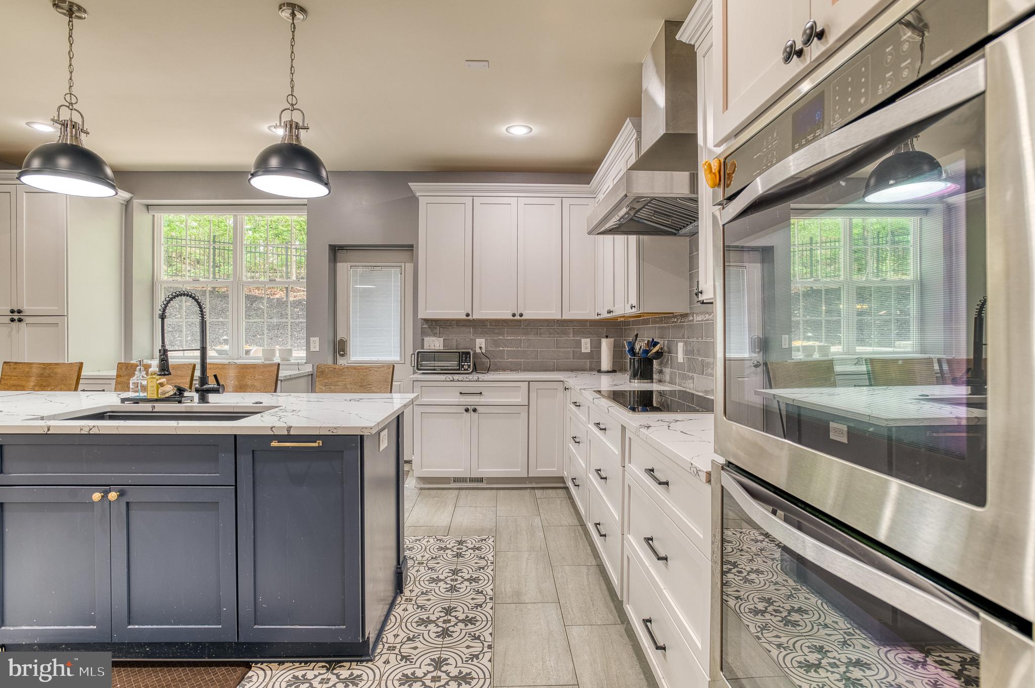 7140 Barry Road Alexandria, VA 22315 - Photo 17 of 56 a kitchen with a sink window and cabinets