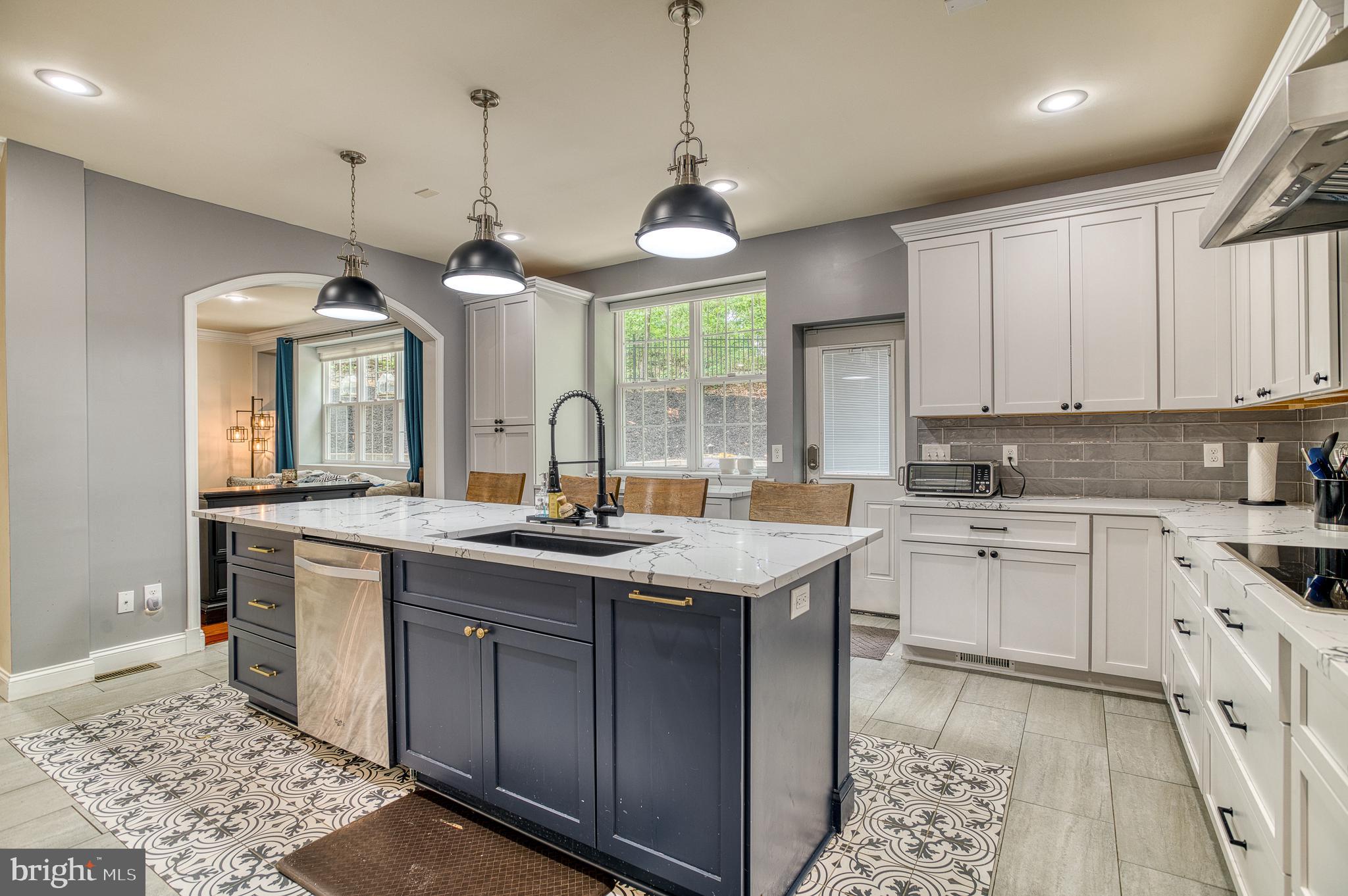 7140 Barry Road Alexandria, VA 22315 - Photo 18 of 56 a kitchen with stainless steel appliances granite countertop a sink stove and refrigerator