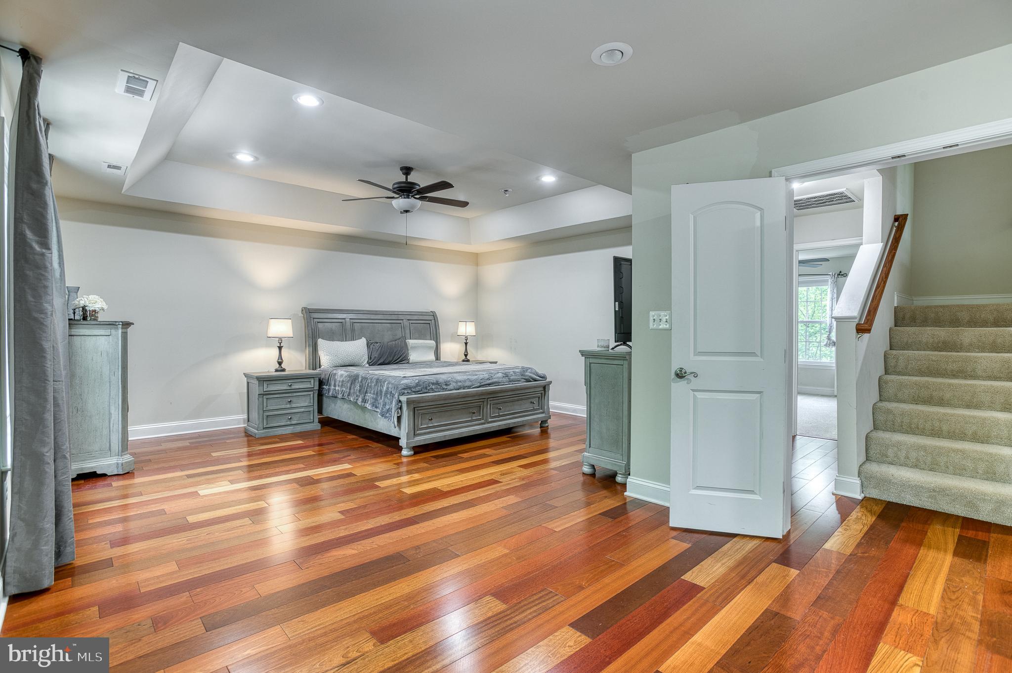 7140 Barry Road Alexandria, VA 22315 - Photo 23 of 56 a bedroom with furniture and a wooden floor