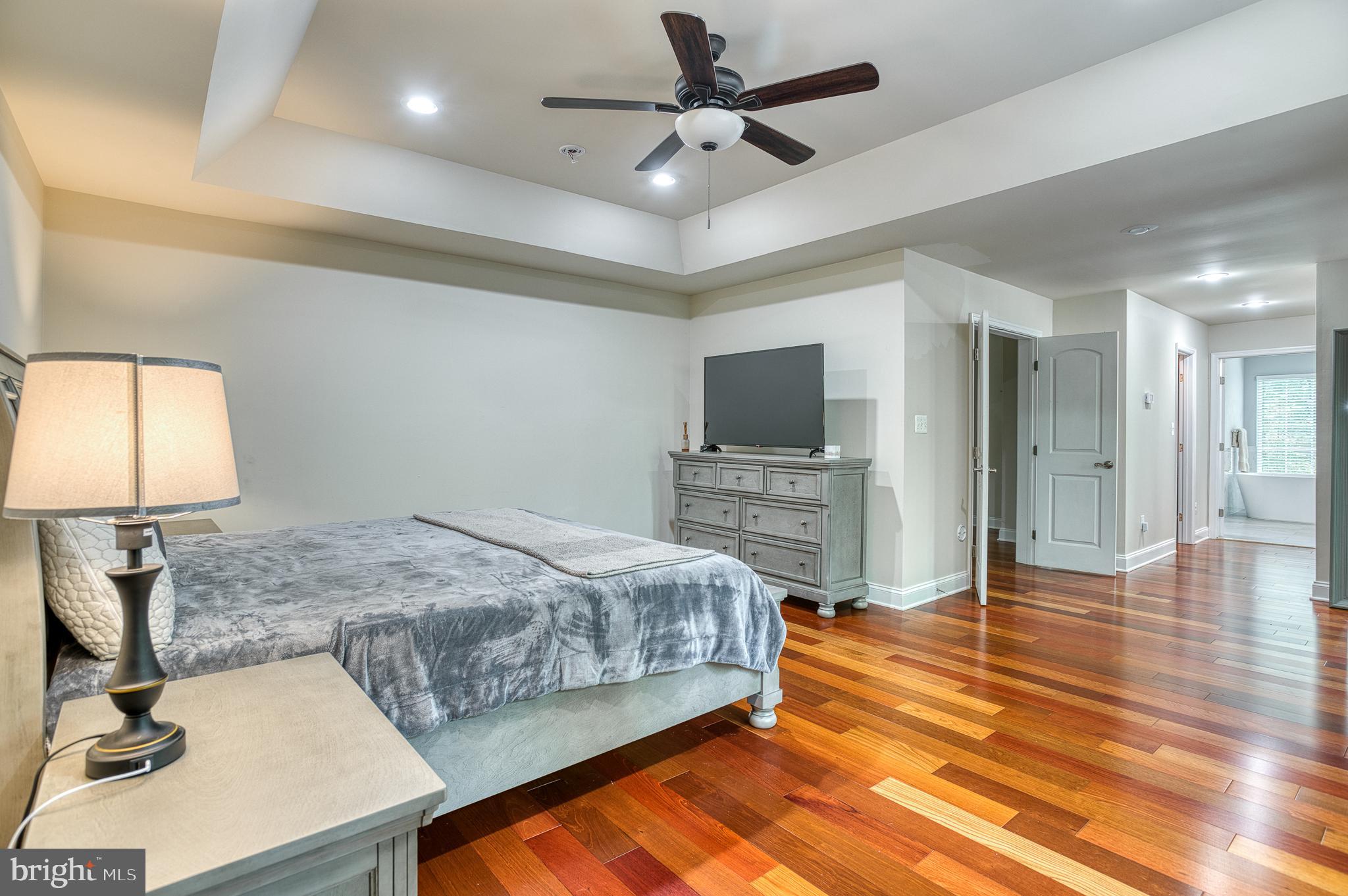 7140 Barry Road Alexandria, VA 22315 - Photo 24 of 56 a bedroom with a bed and a flat screen tv