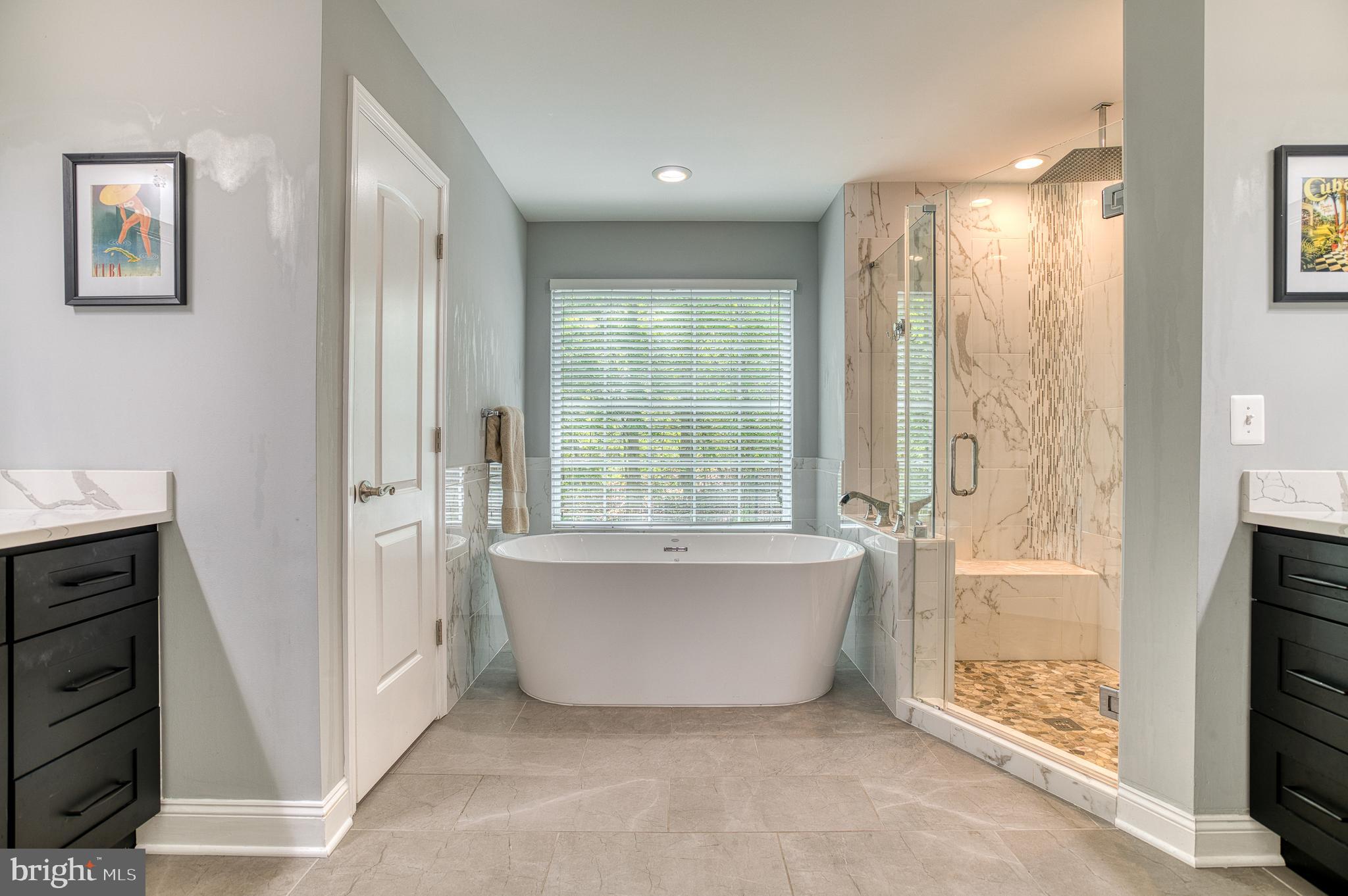 7140 Barry Road Alexandria, VA 22315 - Photo 28 of 56 a bathroom with a bathtub and shower