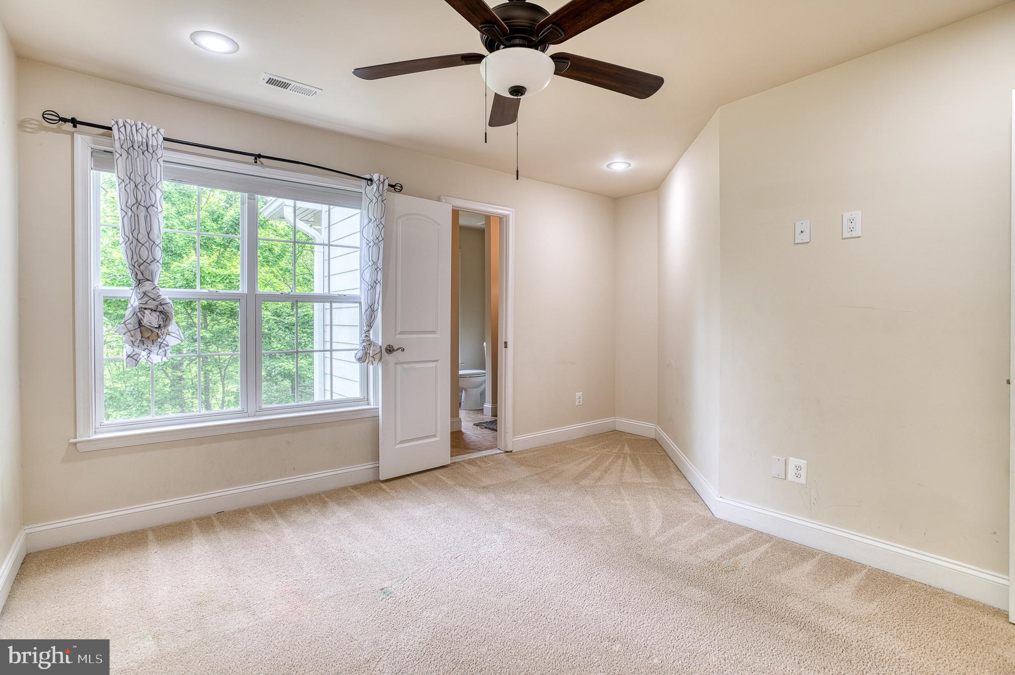 7140 Barry Road Alexandria, VA 22315 - Photo 36 of 56 an empty room with windows and ceiling fan