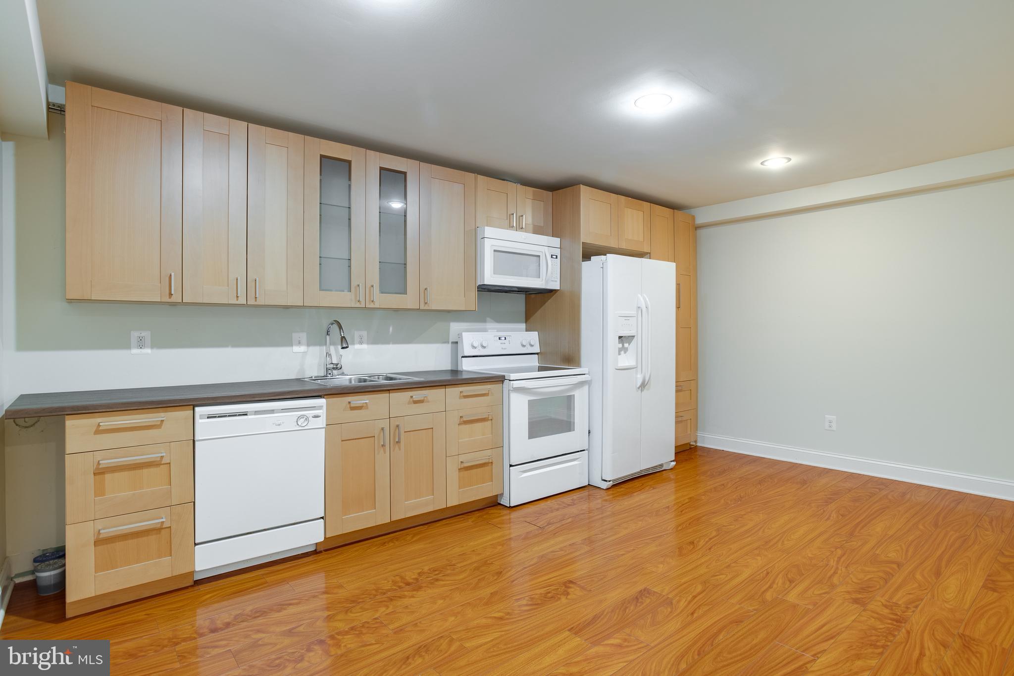 7140 Barry Road Alexandria, VA 22315 - Photo 47 of 56 a kitchen with stainless steel appliances granite countertop a stove a sink dishwasher and a refrigerator with wooden floor