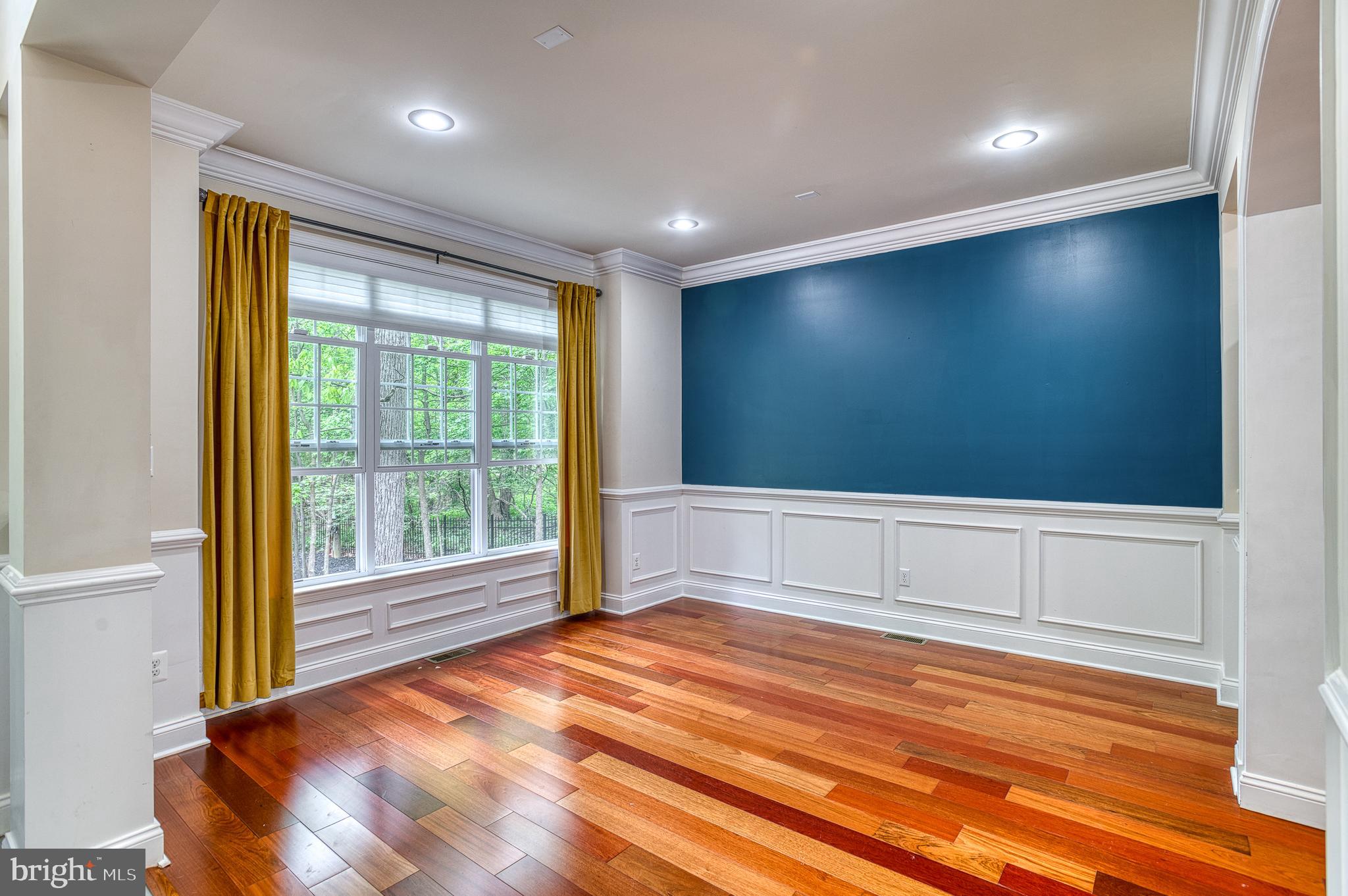 7140 Barry Road Alexandria, VA 22315 - Photo 7 of 56 a view of an empty room with wooden floor and a window