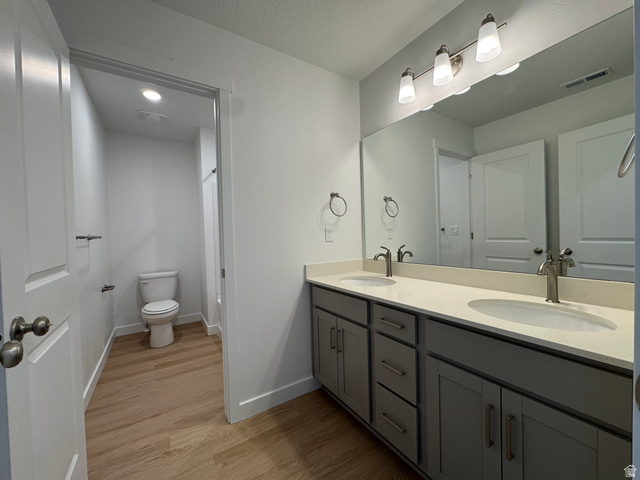 1472 North 1875 West, Unit 151 Layton, UT 84041 - Photo 18 of 20 Dual vanity with gray cabinetry and light-toned countertops, featuring chrome fixtures and a wide mirror