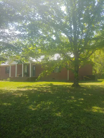 a view of a house with a backyard