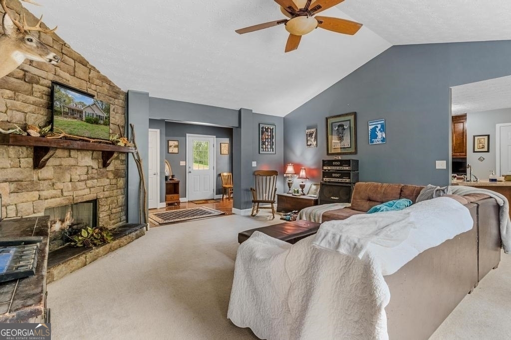 80 Upper Caldwell Road Bowdon, GA 30108 - Photo 5 of 33 a bedroom with furniture a fireplace and a flat screen tv