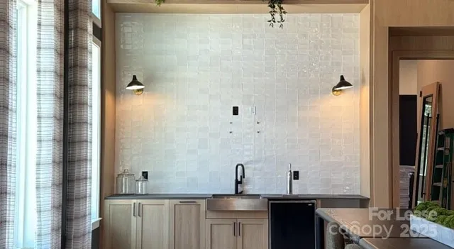 a bathroom with a granite countertop sink a mirror and shower