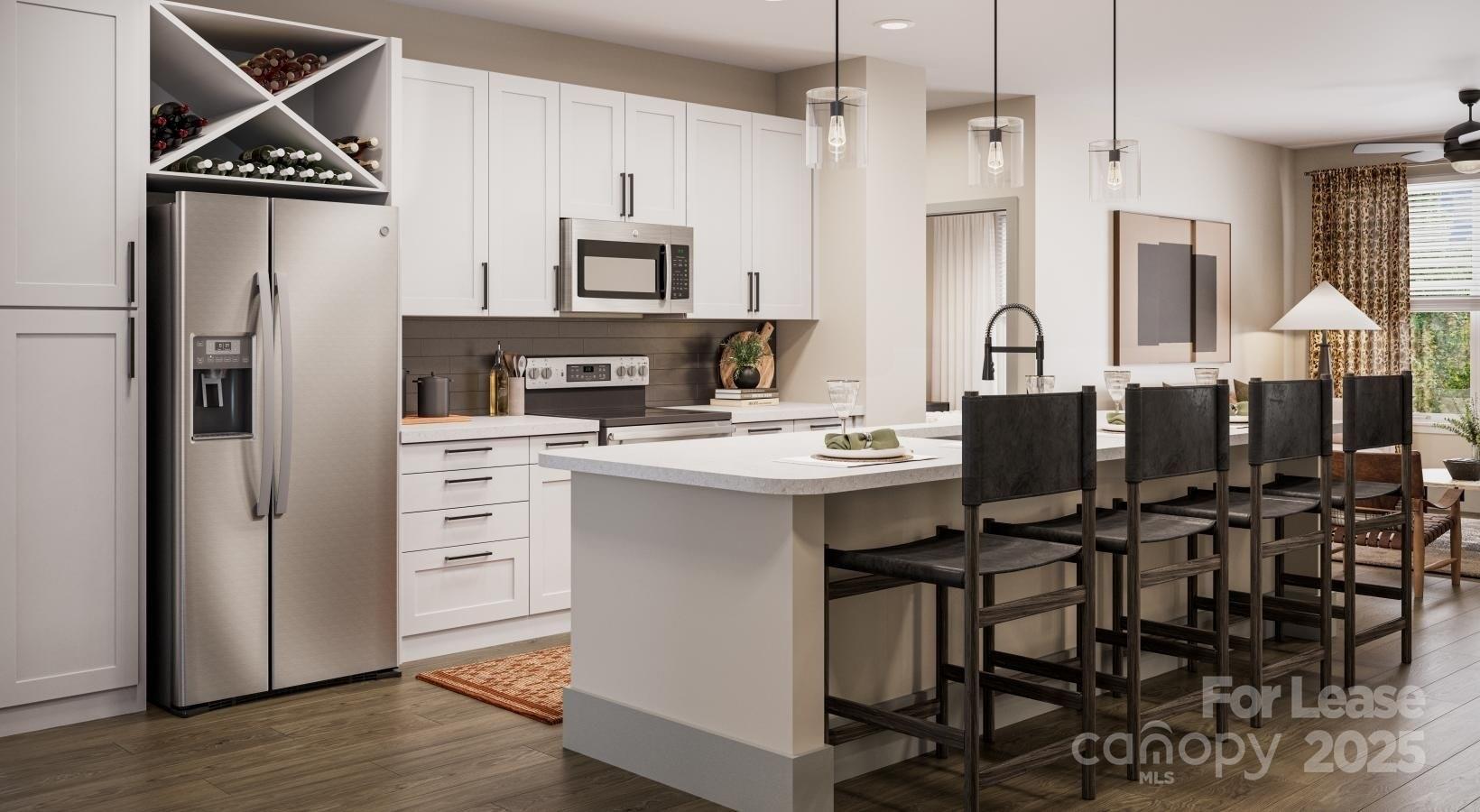 9414 Mallard Creek Road, Unit ALEXANDER Charlotte, NC 28262 - Photo 10 of 13 a room with stainless steel appliances kitchen island a table chairs and a refrigerator