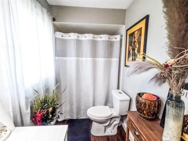 a bathroom with a toilet sink and shower
