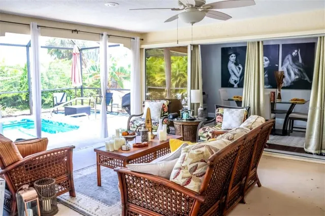 a dining room with furniture a chandelier and a floor to ceiling window