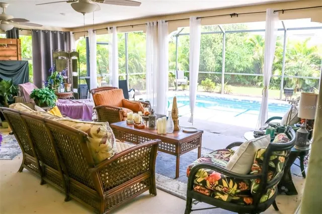 a living room with furniture and a floor to ceiling window