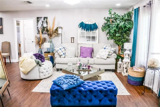 a living room with furniture and a large mirror