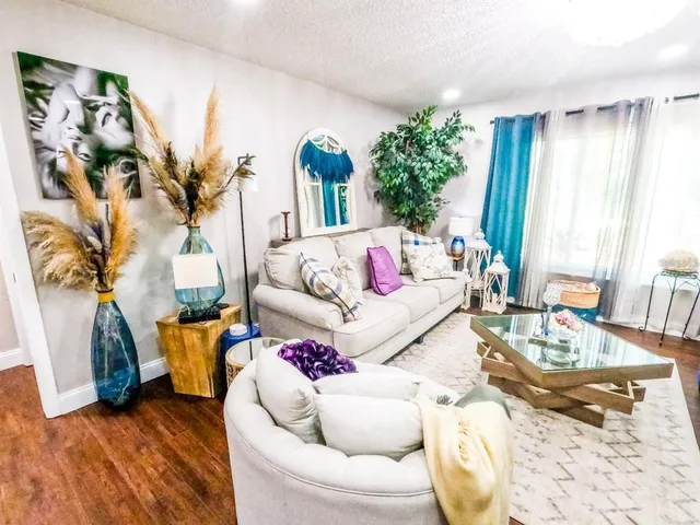 a living room with furniture and a large window