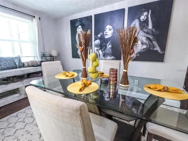 a dining room with furniture and wooden floor
