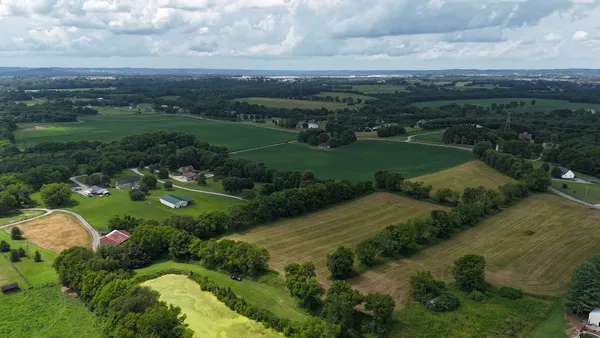 an aerial view of a golf course with a lake view