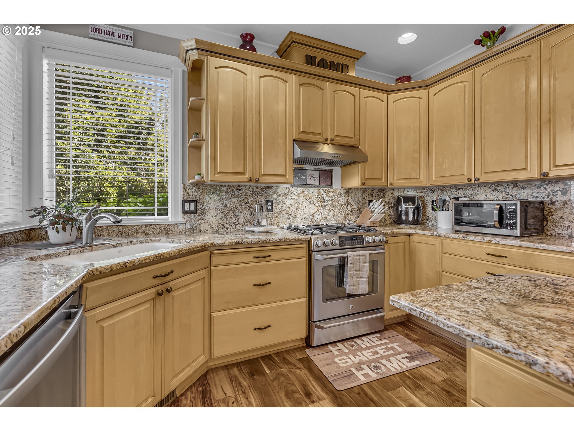 6336 Nicklaus Loop North Keizer, OR 97303 - Photo 15 of 45 a kitchen with stainless steel appliances granite countertop a stove a sink and a microwave