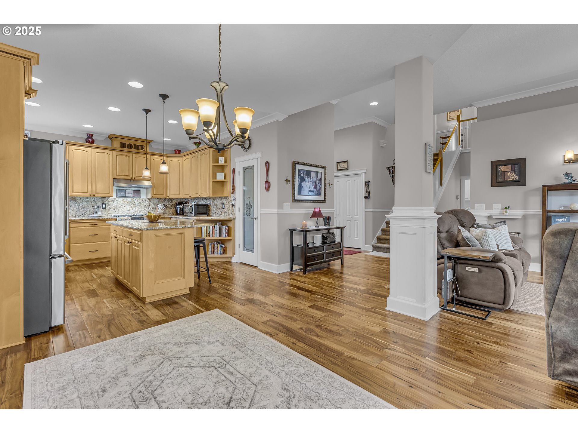6336 Nicklaus Loop North Keizer, OR 97303 - Photo 17 of 45 a living room with kitchen island furniture and a chandelier