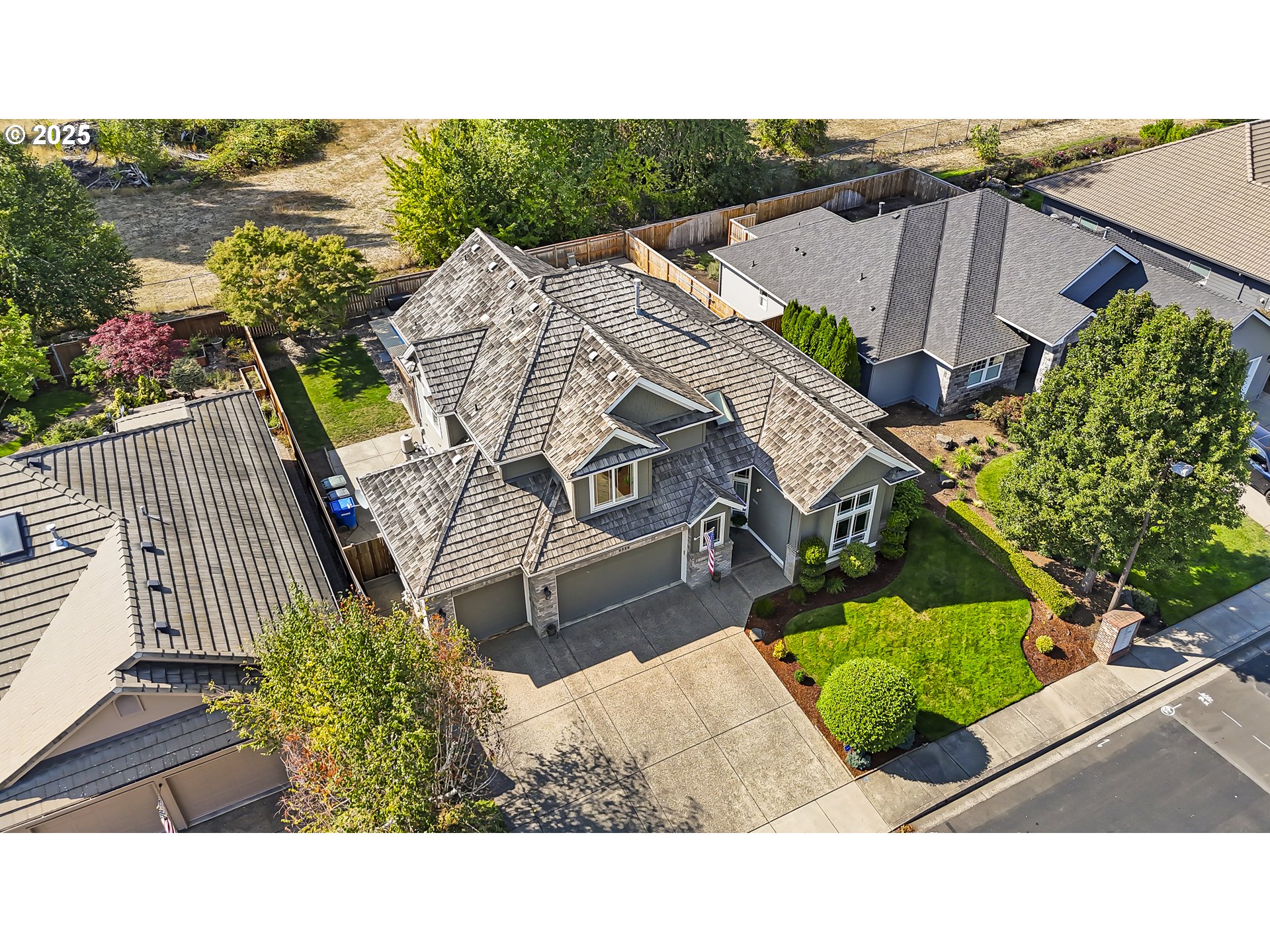 6336 Nicklaus Loop North Keizer, OR 97303 - Photo 2 of 45 a view of a swimming pool with a patio and a garden