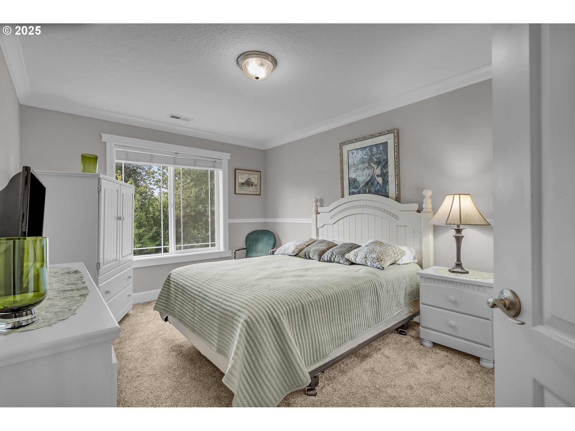 6336 Nicklaus Loop North Keizer, OR 97303 - Photo 29 of 45 a bedroom with a bed and a flat screen tv