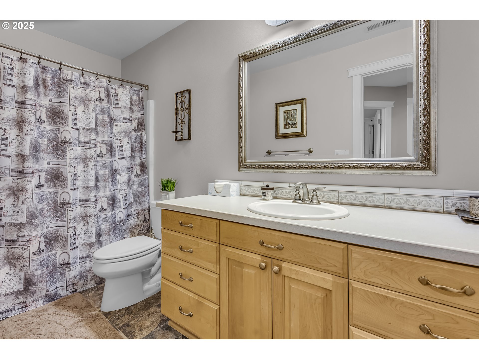 6336 Nicklaus Loop North Keizer, OR 97303 - Photo 31 of 45 a bathroom with a granite countertop toilet a sink a mirror and a shower curtain