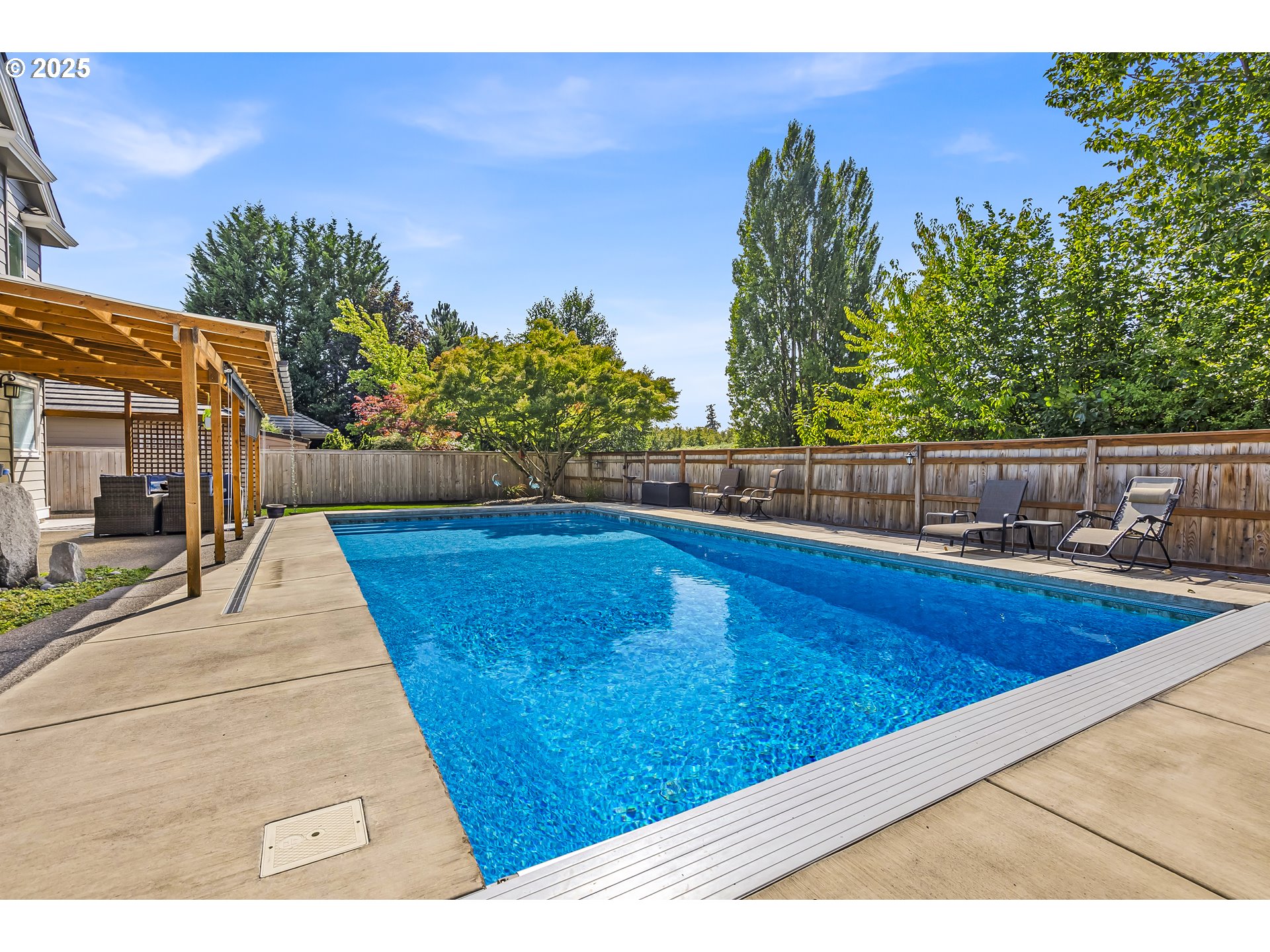 6336 Nicklaus Loop North Keizer, OR 97303 - Photo 36 of 45 a view of a swimming pool with an outdoor seating and a yard