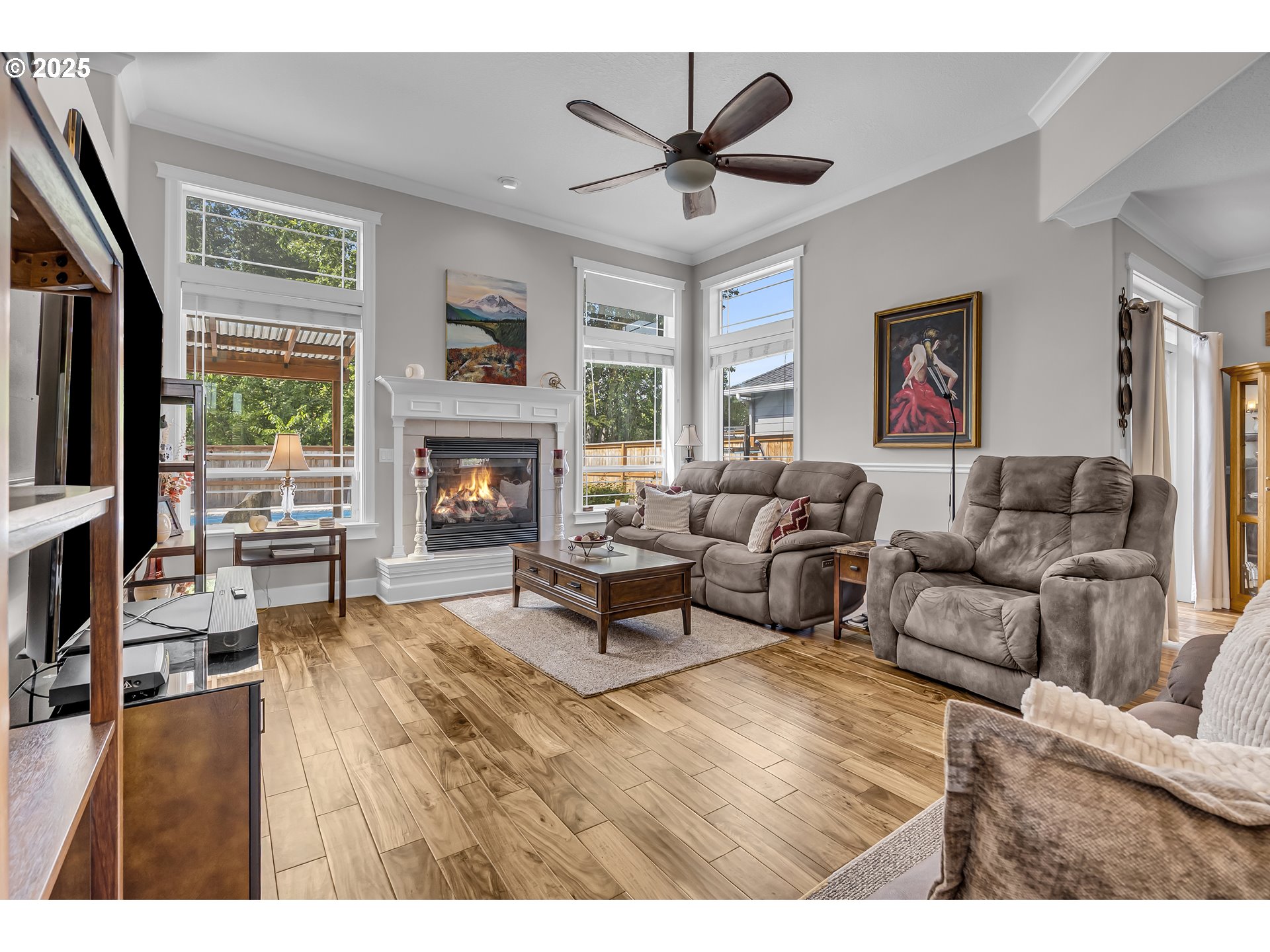 6336 Nicklaus Loop North Keizer, OR 97303 - Photo 10 of 45 a living room with furniture a fireplace and a flat screen tv
