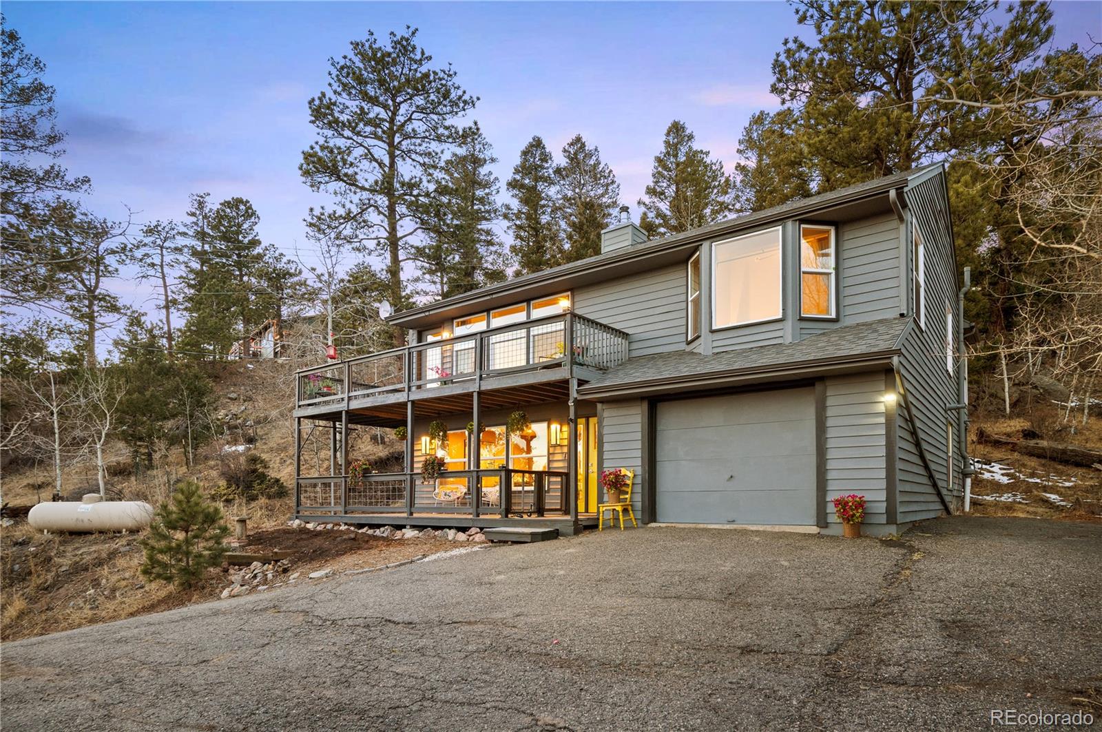 11740 Baca Road Conifer, CO 80433 - Photo 39 of 49 a front view of a house with a yard and garage