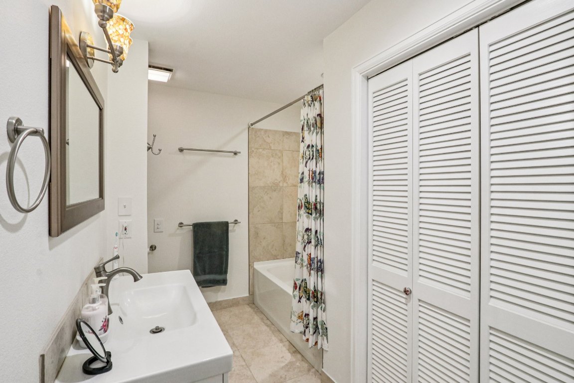428 Gotier Trace Road Smithville, TX 78957 - Photo 23 of 40 Bathroom with shower / bath combo, a closet, and vanity