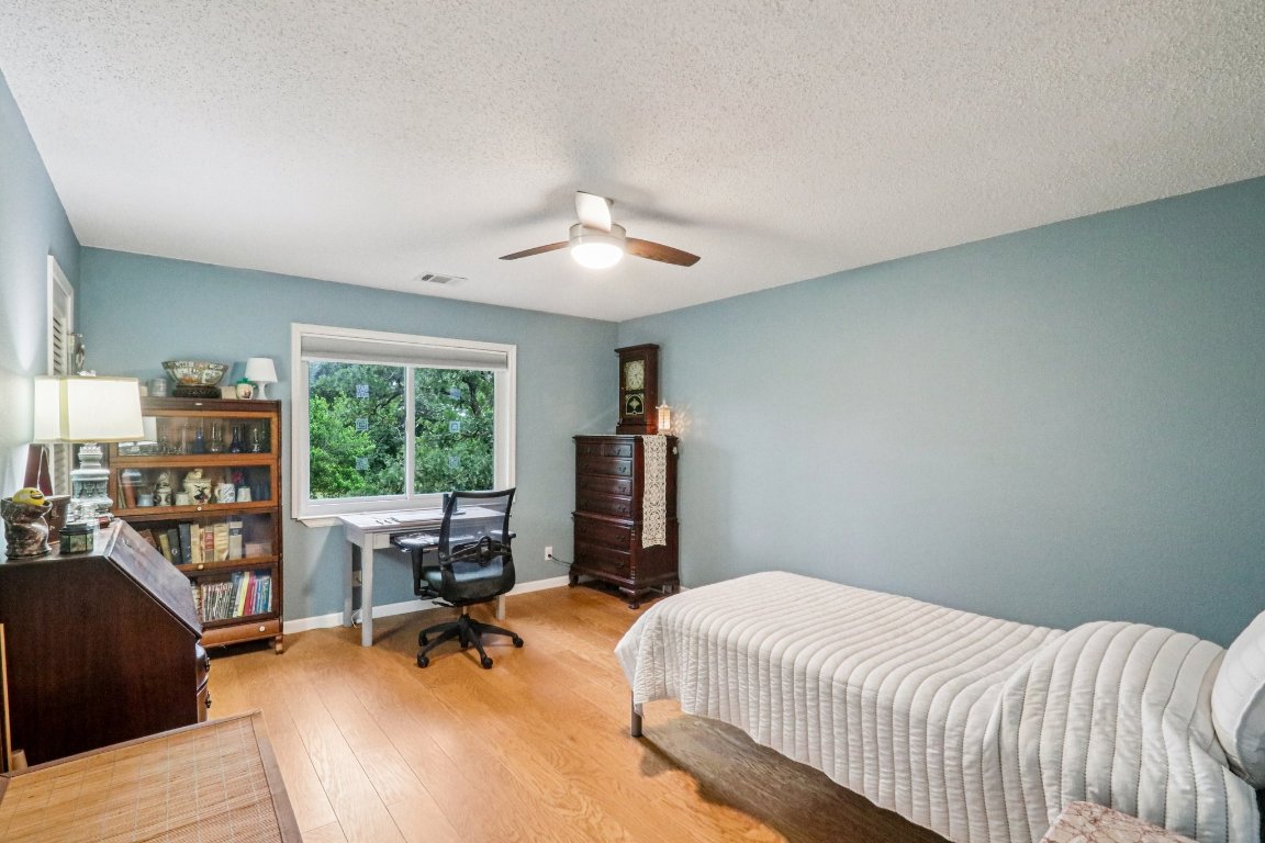 428 Gotier Trace Road Smithville, TX 78957 - Photo 27 of 40 Bedroom with wood finished floors, a textured ceiling, and ceiling fan