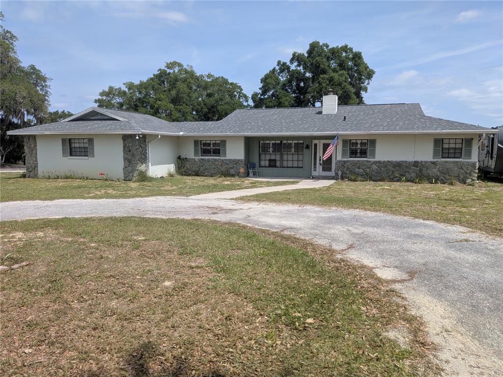 8801 East Cresco Lane Inverness, FL 34450 - Photo 1 of 51 a front view of a house with a yard