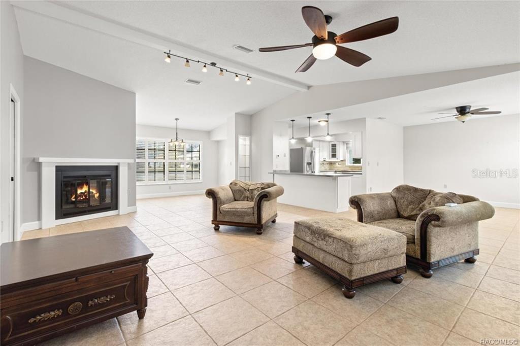 8801 East Cresco Lane Inverness, FL 34450 - Photo 14 of 51 a living room with furniture and a fireplace