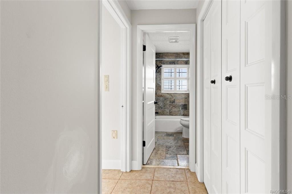 8801 East Cresco Lane Inverness, FL 34450 - Photo 17 of 51 a bathroom with a glass door and shower