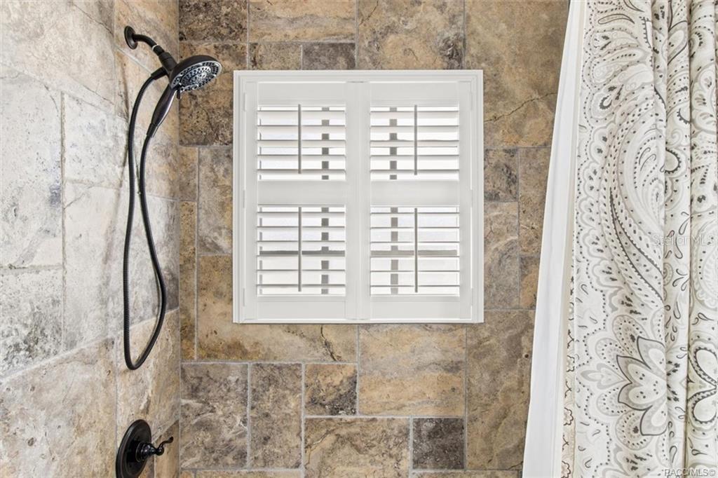 8801 East Cresco Lane Inverness, FL 34450 - Photo 27 of 51 a view of a bathroom shower and a window
