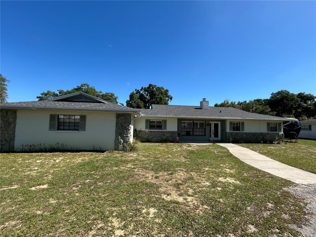 8801 East Cresco Lane Inverness, FL 34450 - Photo 3 of 51 a view of a house with a yard