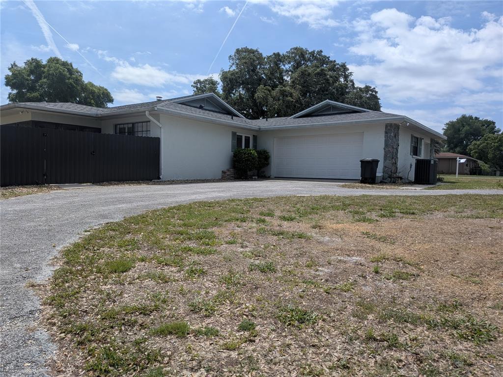 8801 East Cresco Lane Inverness, FL 34450 - Photo 7 of 51 a view of a house with a yard and garage