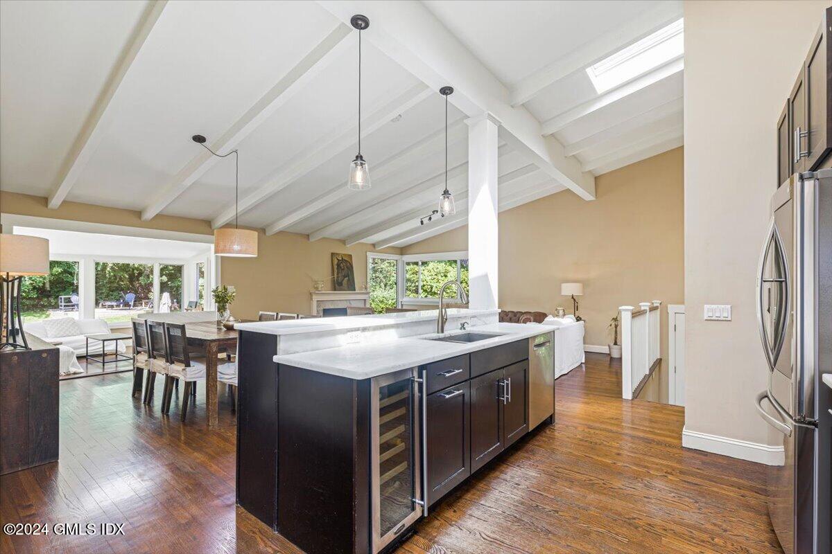 70 Gregory Road Cos Cob, CT 06807 - Photo 9 of 39 a kitchen with a table chairs wooden floors and a view of living room