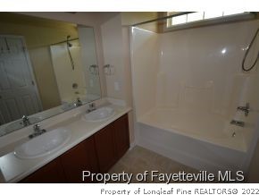 546 Cape Fear Road Raeford, NC 28376 - Photo 13 of 13 a bathroom with a sink a shower and a mirror
