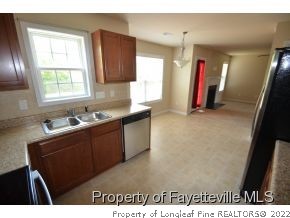 546 Cape Fear Road Raeford, NC 28376 - Photo 3 of 13 a kitchen with granite countertop a sink cabinets and a window