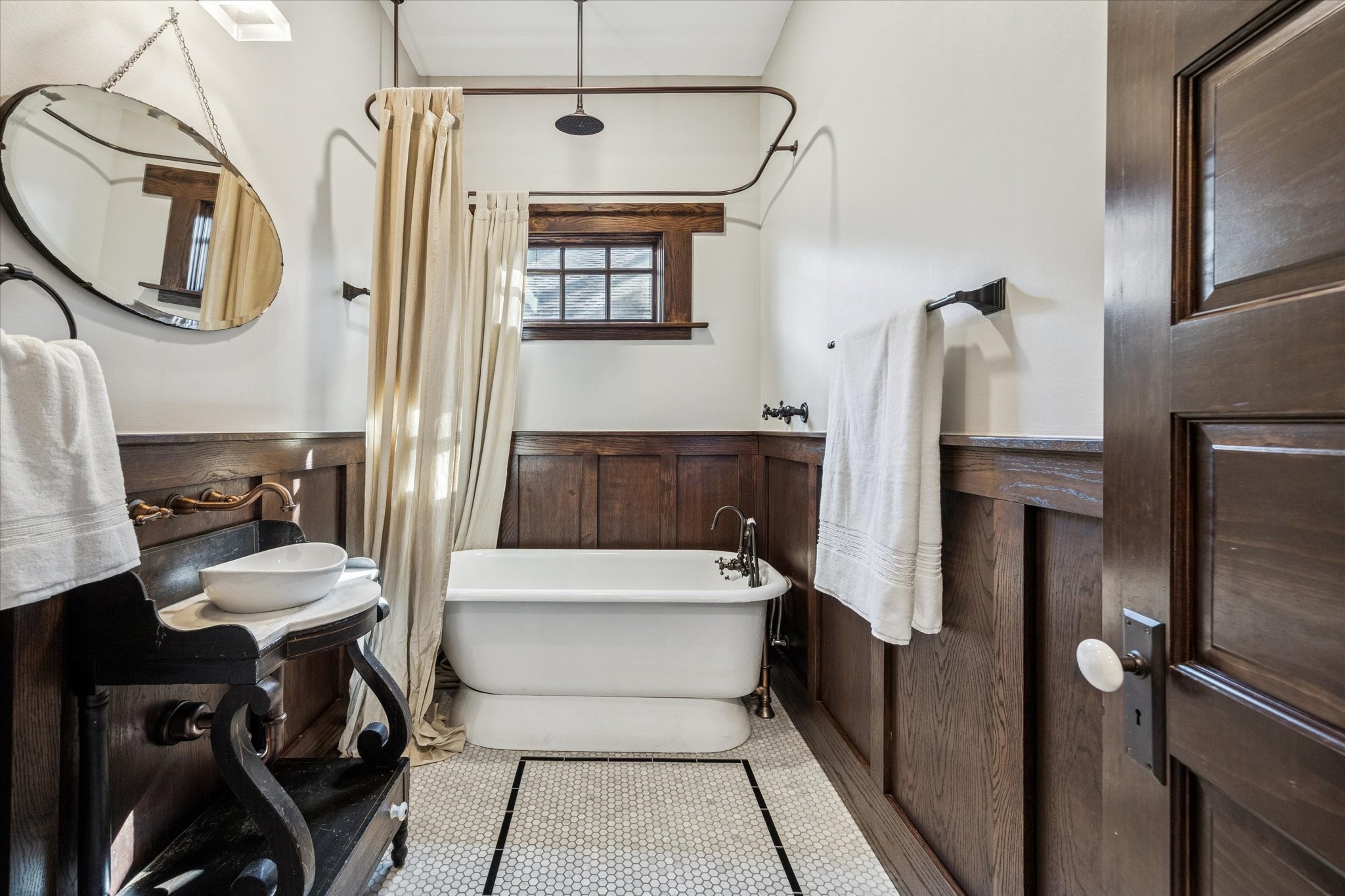 512 Archer Street Houston, TX 77009 - Photo 28 of 40 Conveniently located on the first floor, this full bath boasts a tile rug inlay, soaking tub with rain shower head, and marble countertop with top-mount sink.