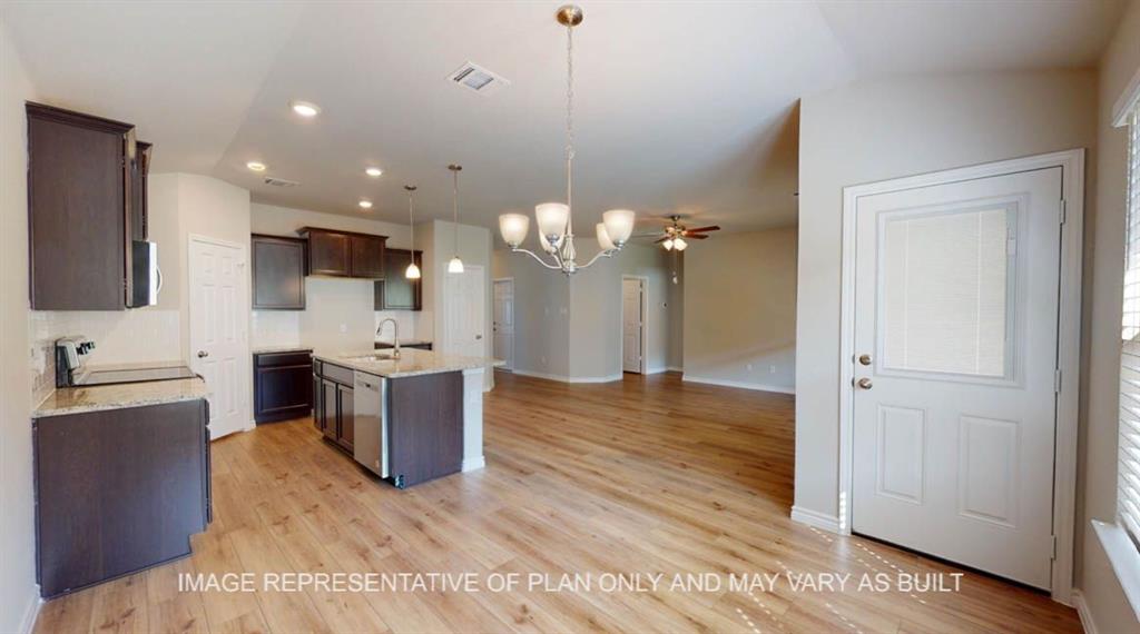 10113 Neptune Court Waco, TX 76708 - Photo 8 of 24 Open-concept living space with wood-finish flooring, a kitchen island, dark wood cabinetry, stainless steel appliances, and recessed lighting