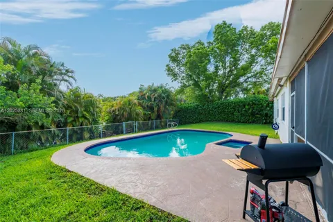 a view of swimming pool with lounge chair in the patio