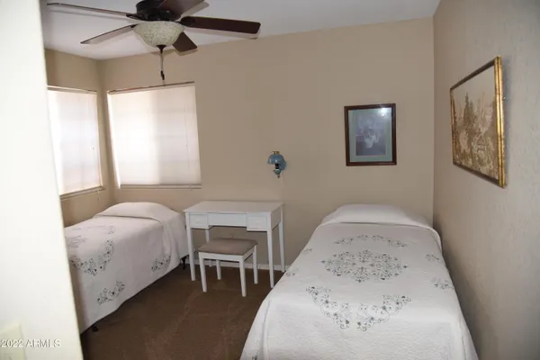 a bedroom with a bed and a table