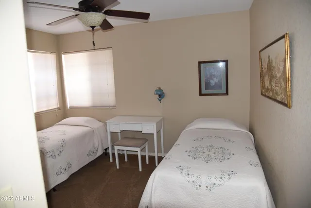 a bedroom with a bed and a table