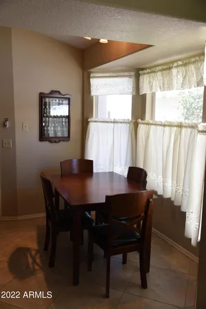 a view of a dining room with furniture and a large window